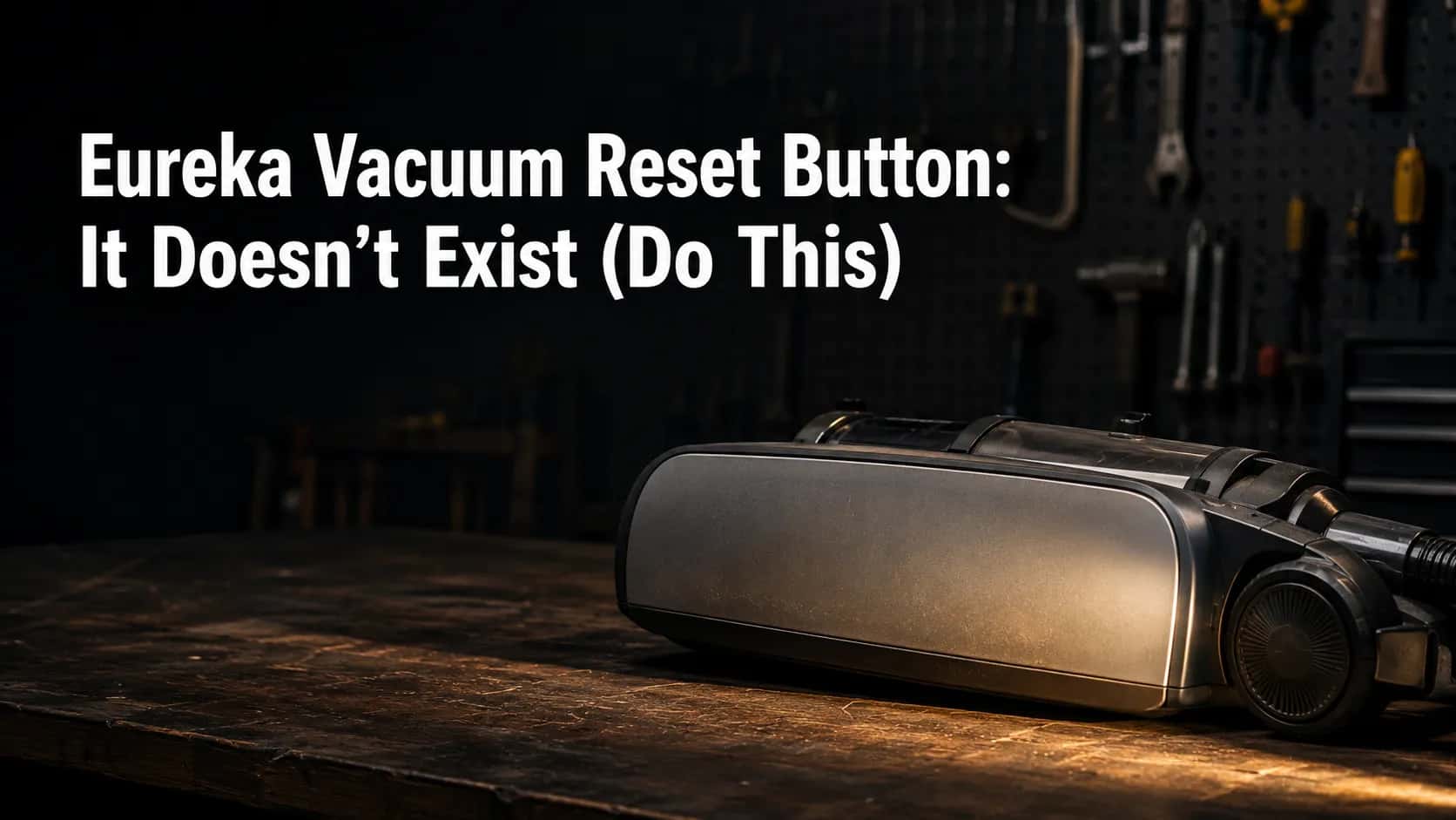 Grey and black upright vacuum lying on its side on a workshop bench as a torch highlights the blank side panel with no reset button.