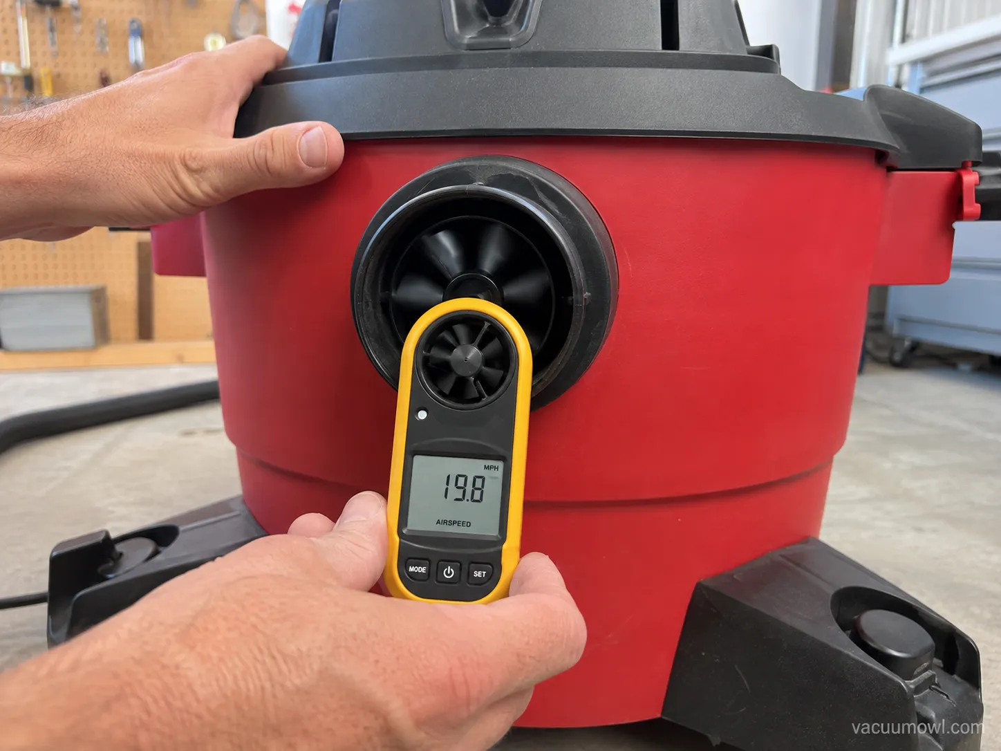 anemometer measuring airflow at a shop vac rear blower port