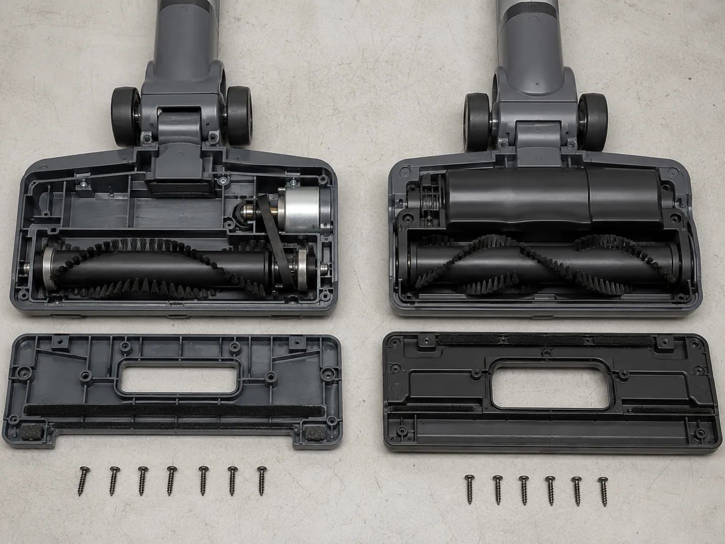 Side-by-side teardown of a Bissell CleanView belt-driven brush roll and a CleanView XR beltless floor head with the sole plates removed.