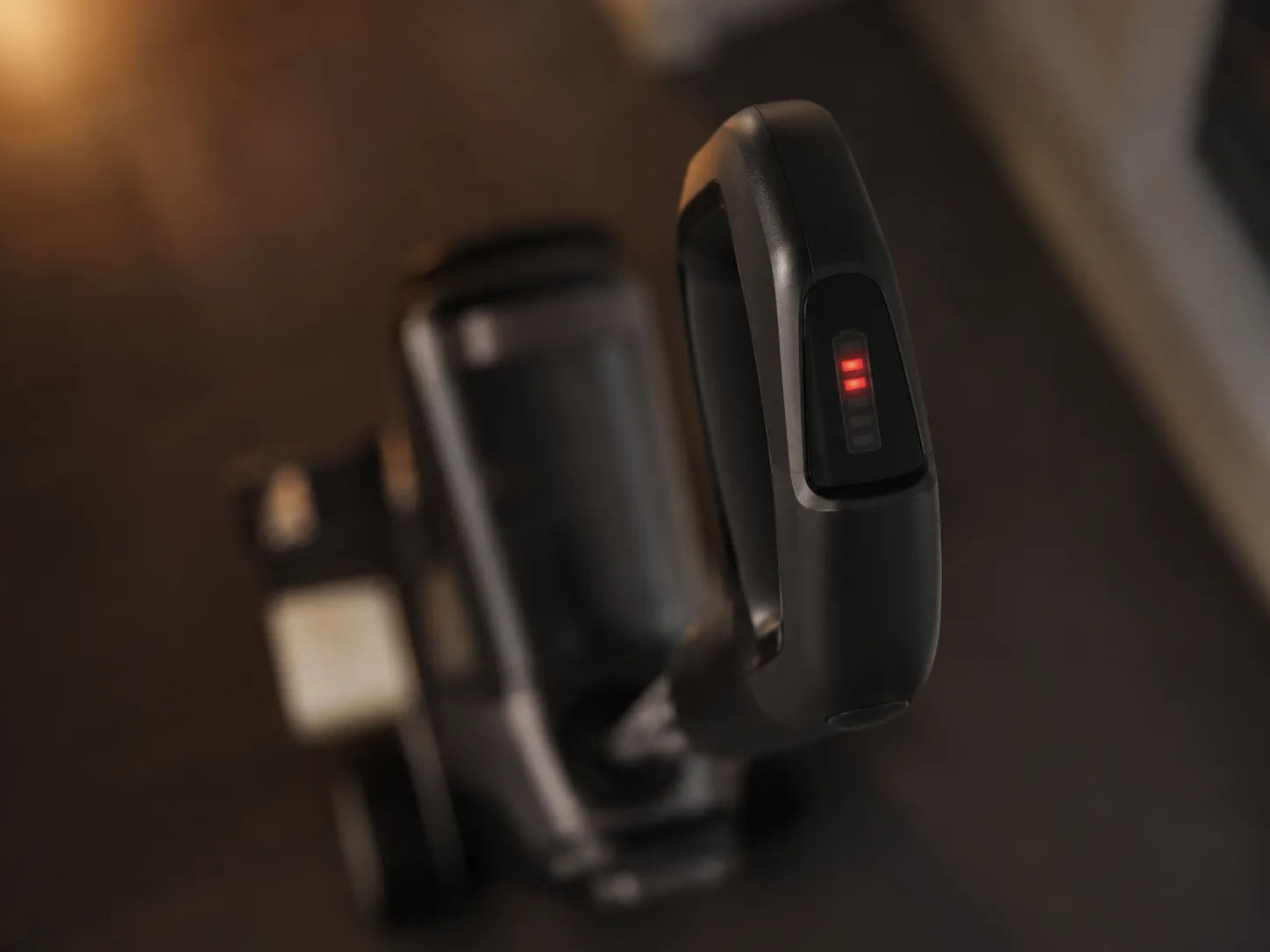 Close-up of a cordless floor cleaner handle display showing two illuminated red warning lights, indicating an error that may be cleared through the dock cycle.