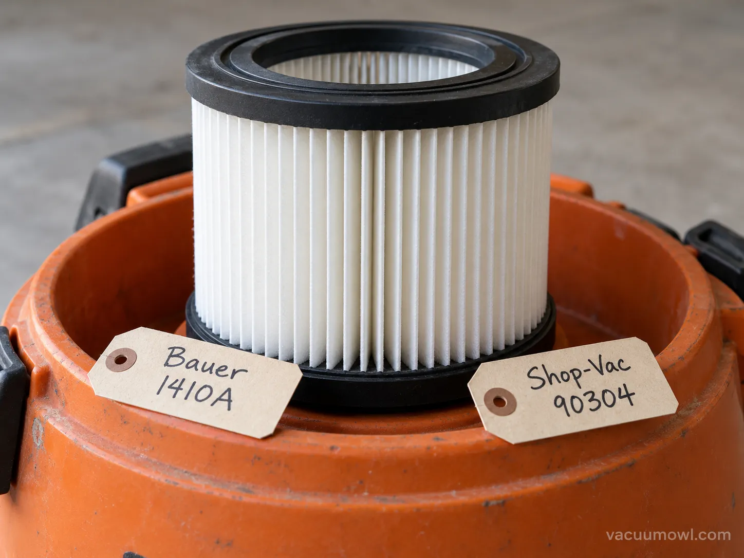 cross-fit replacement filter fitted on a Bauer shop vac with part numbers labeled.