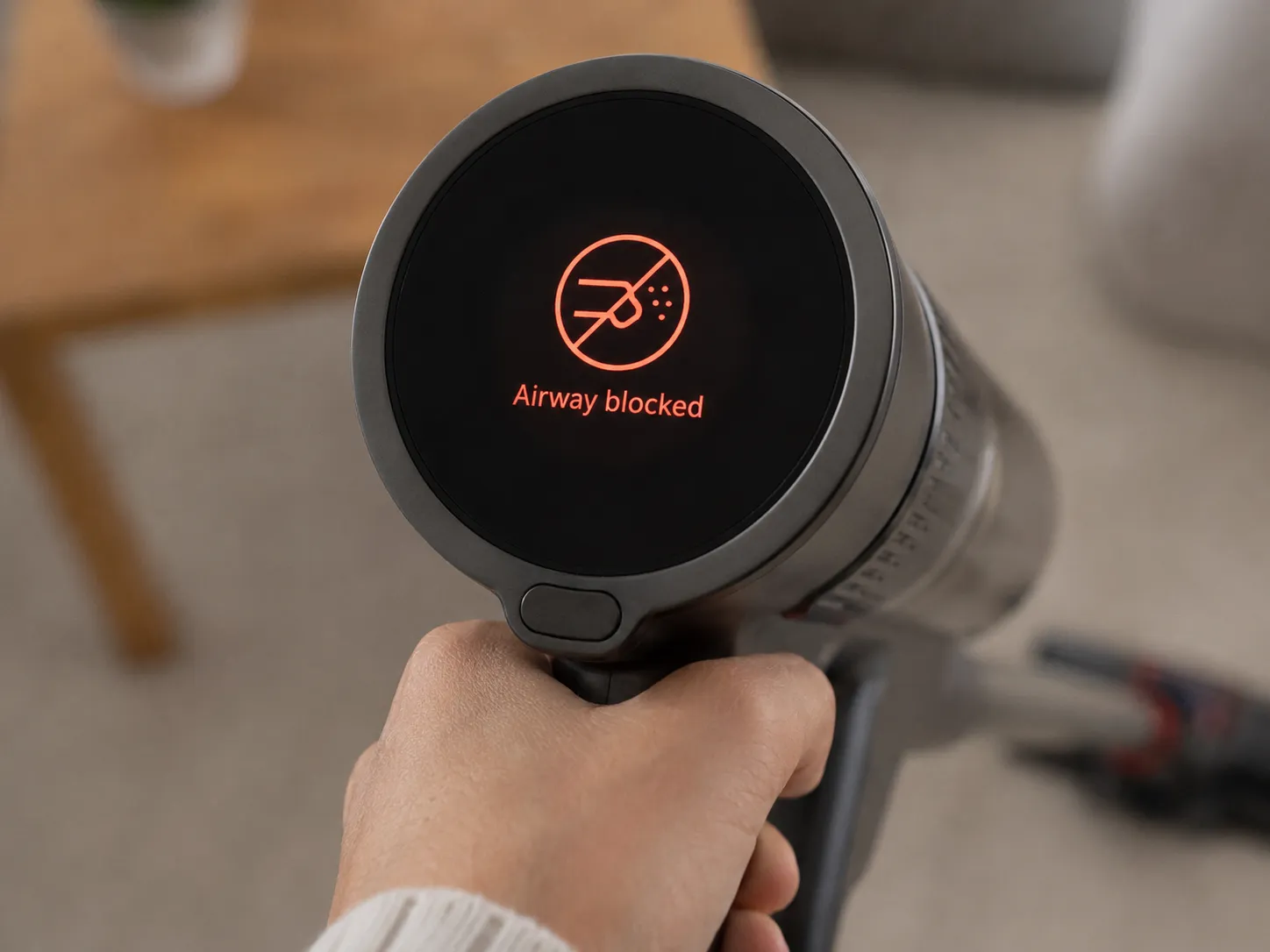 Close-up of a Dyson Gen5 vacuum LCD screen showing an airway blockage alert during a bench test.