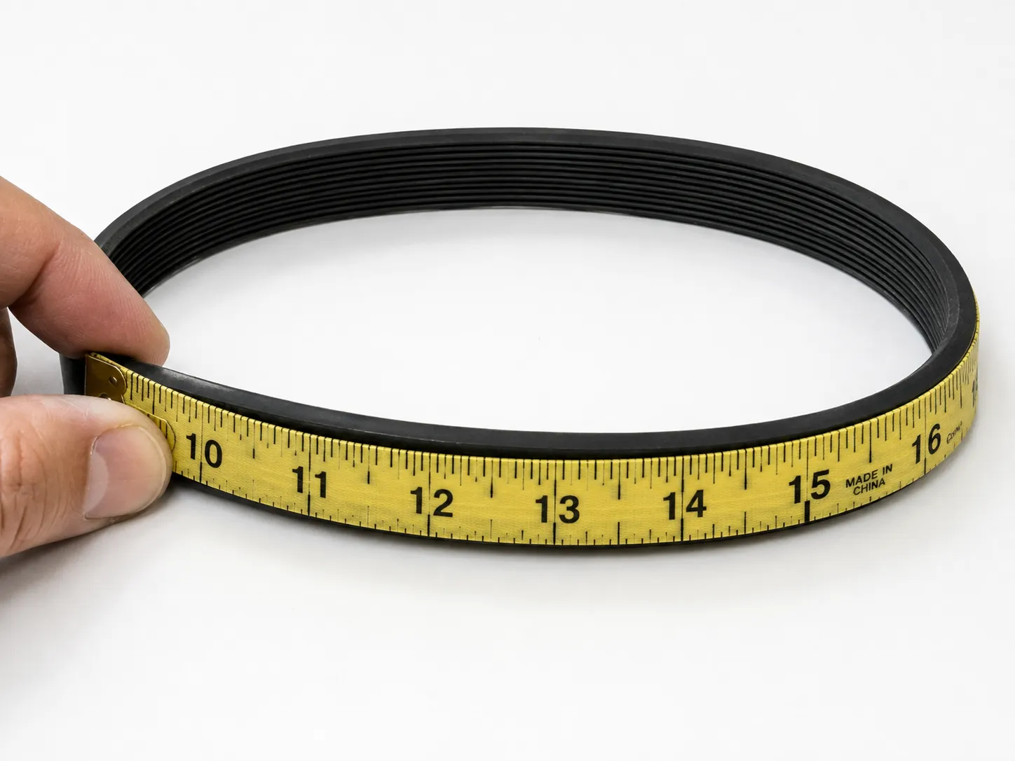 measuring a vacuum belt perimeter with a tape measure for the correct replacement size