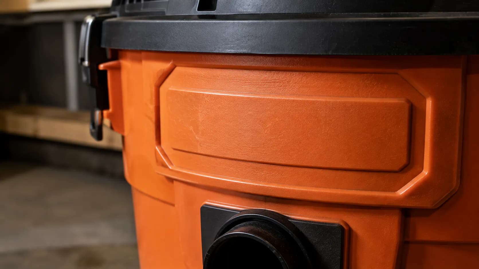 Close-up of the moulded brand nameplate on a shop vac housing