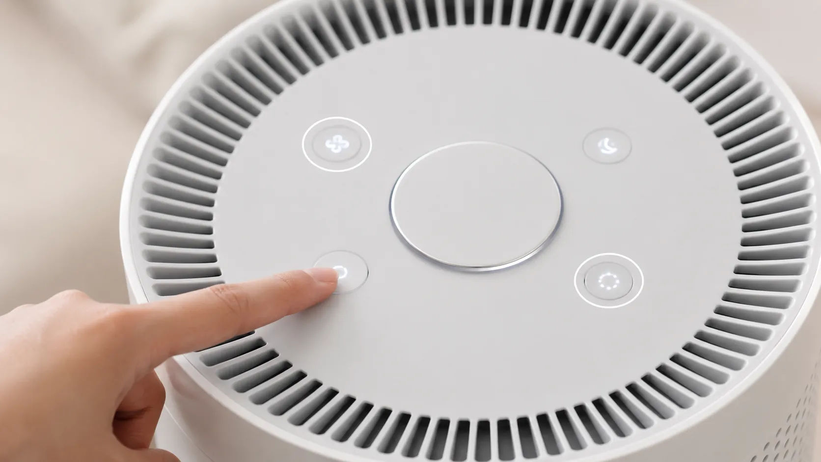 Close-up of the Bissell air180 control panel showing that the light dim button performs the reset while holding the power button only switches the air purifier off.