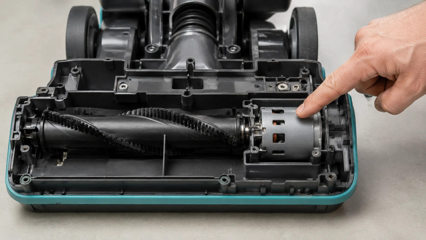 Exposed underside of a Eureka FloorRover floor head showing the brush roll driven directly by its own motor, with no belt in the assembly.