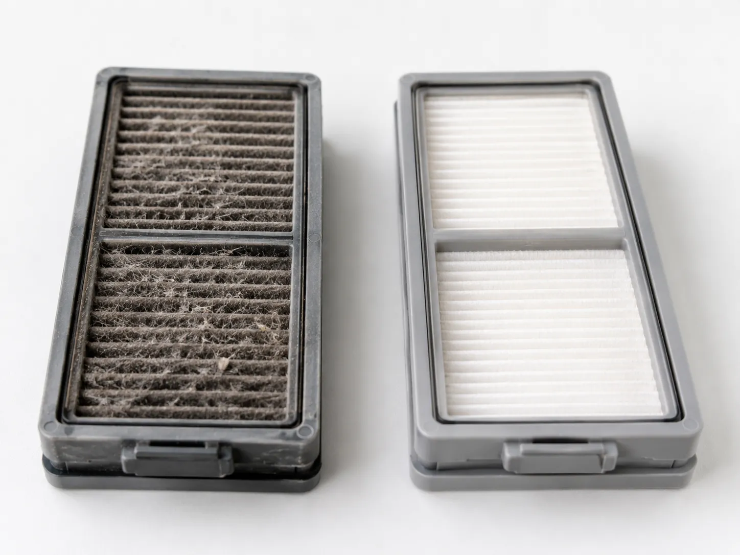 clogged robot vacuum filter next to a cleaned filter