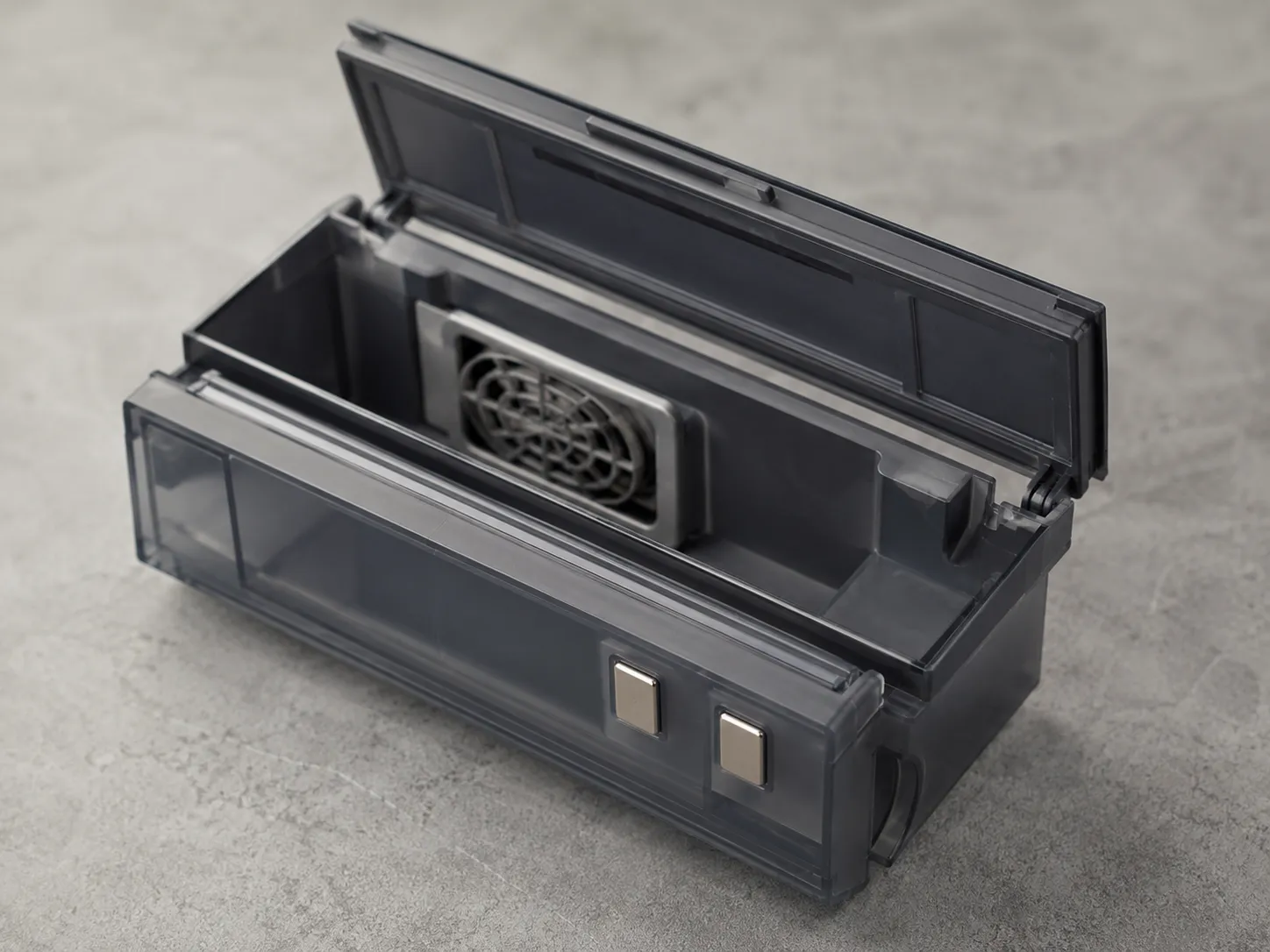 Open robot vacuum dust bin showing the metal contact strips and internal fan grille that can trigger a false bin-full error.